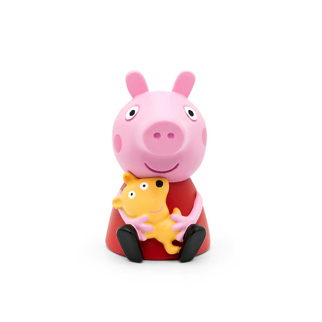Toy figure of a pink pig with a yellow bear on a white background