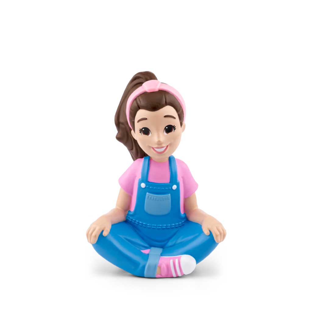 Toy figure of a girl in blue overalls and pink shirt on a white background