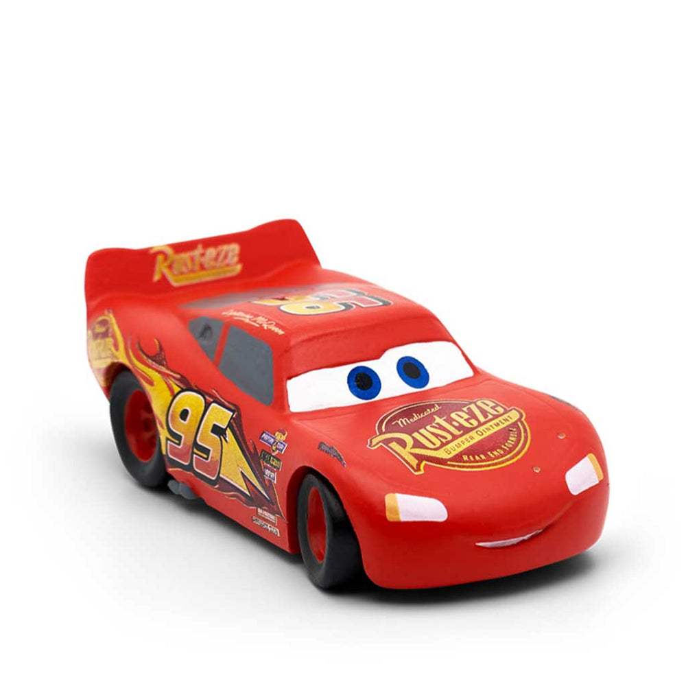 Red toy car with blue eyes on a white background