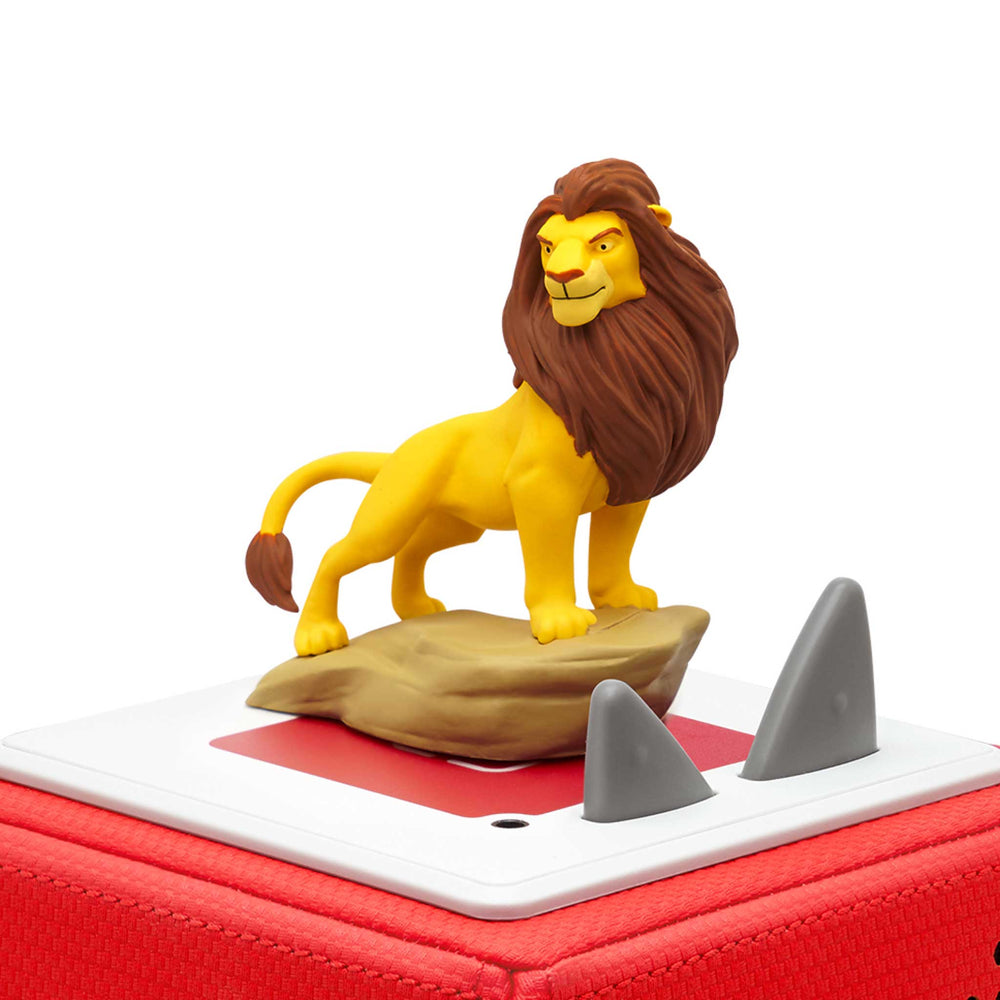 Toy figure of a lion on a red and white base with shark fins.