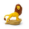Toy figure of a lion standing on a rock with a white background
