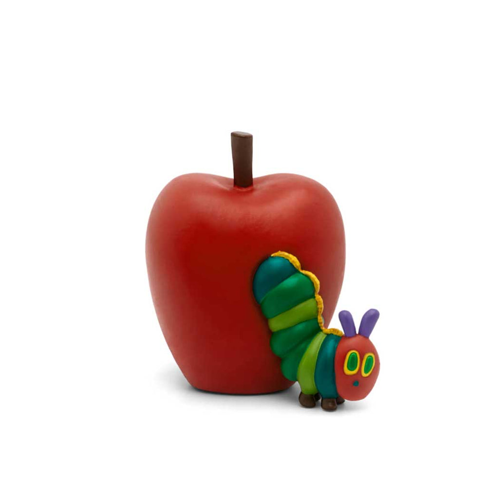 Red apple with a colorful caterpillar toy on a white background