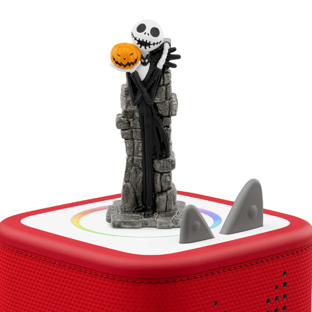 Skeleton figure with a pumpkin head on a red Toni box.