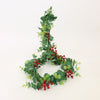 Decorative wreath with green leaves and red berries on a white background