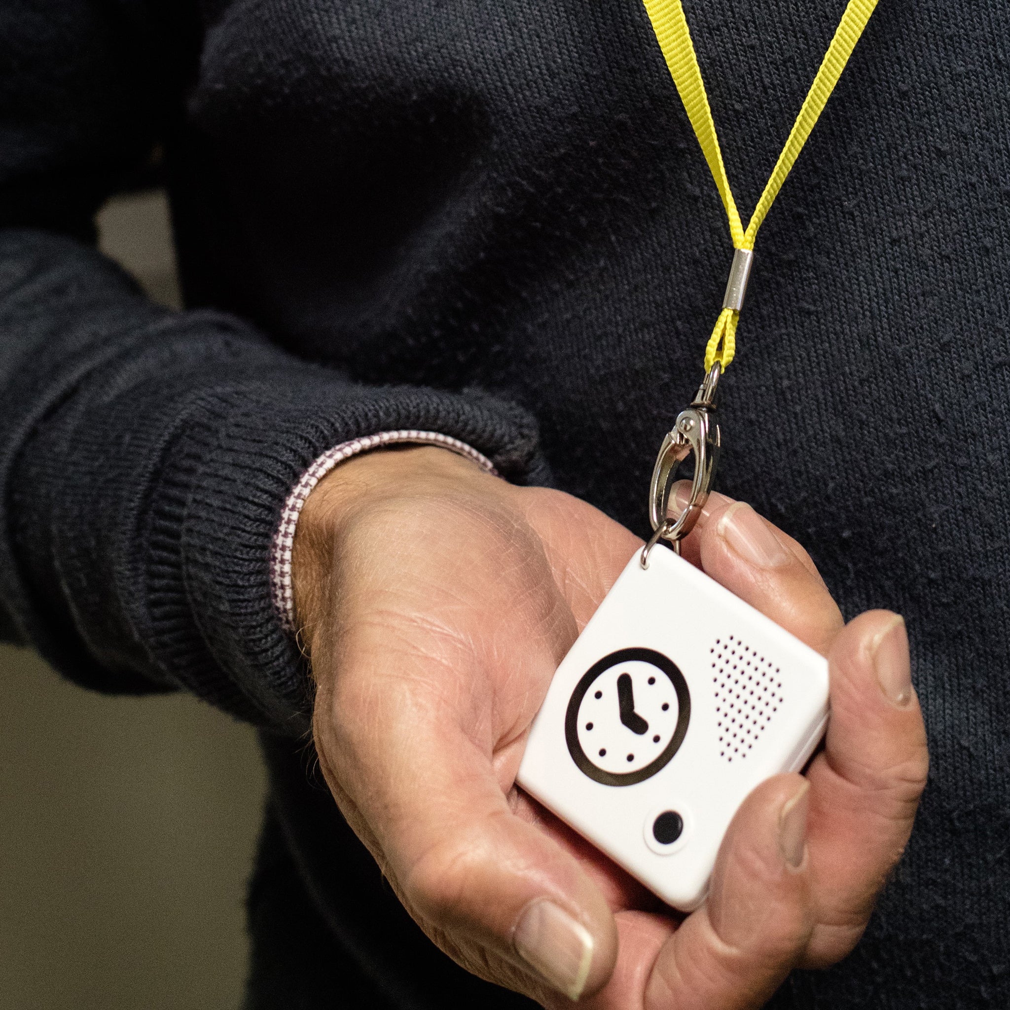Someone wearing the talking pocket clock on a lanyard