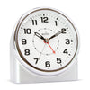 Silver alarm clock with black numbers and red second hand on a white background