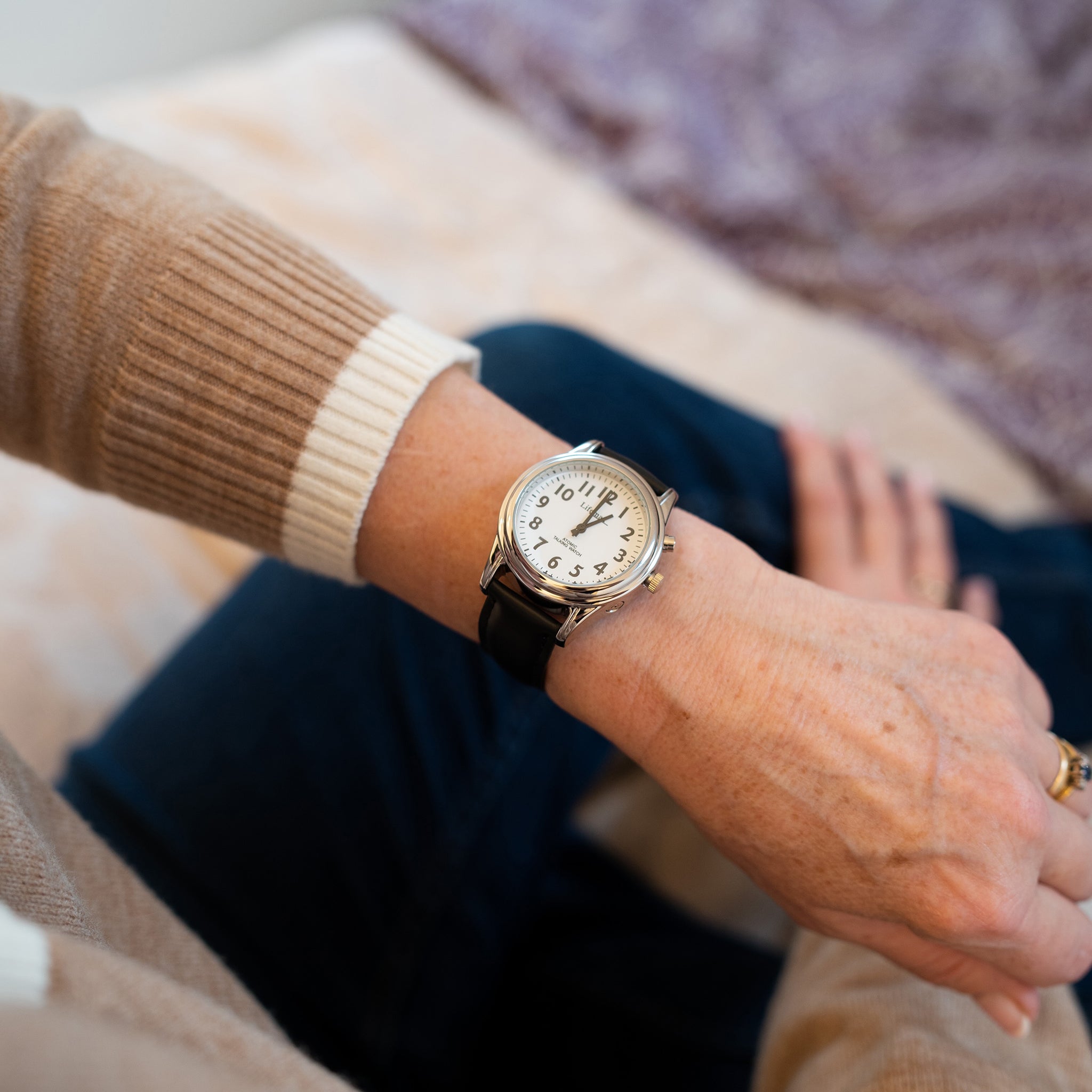 Someone wearing the watch with black leather strap