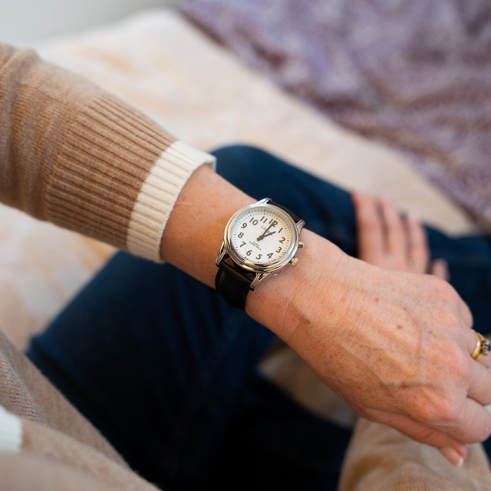 Someone wearing the watch with black leather strap