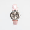 Front view of tactile watch with strap buckled up against a white background