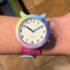 Rainbow-coloured slap on wrist strap talking children's watch being worn