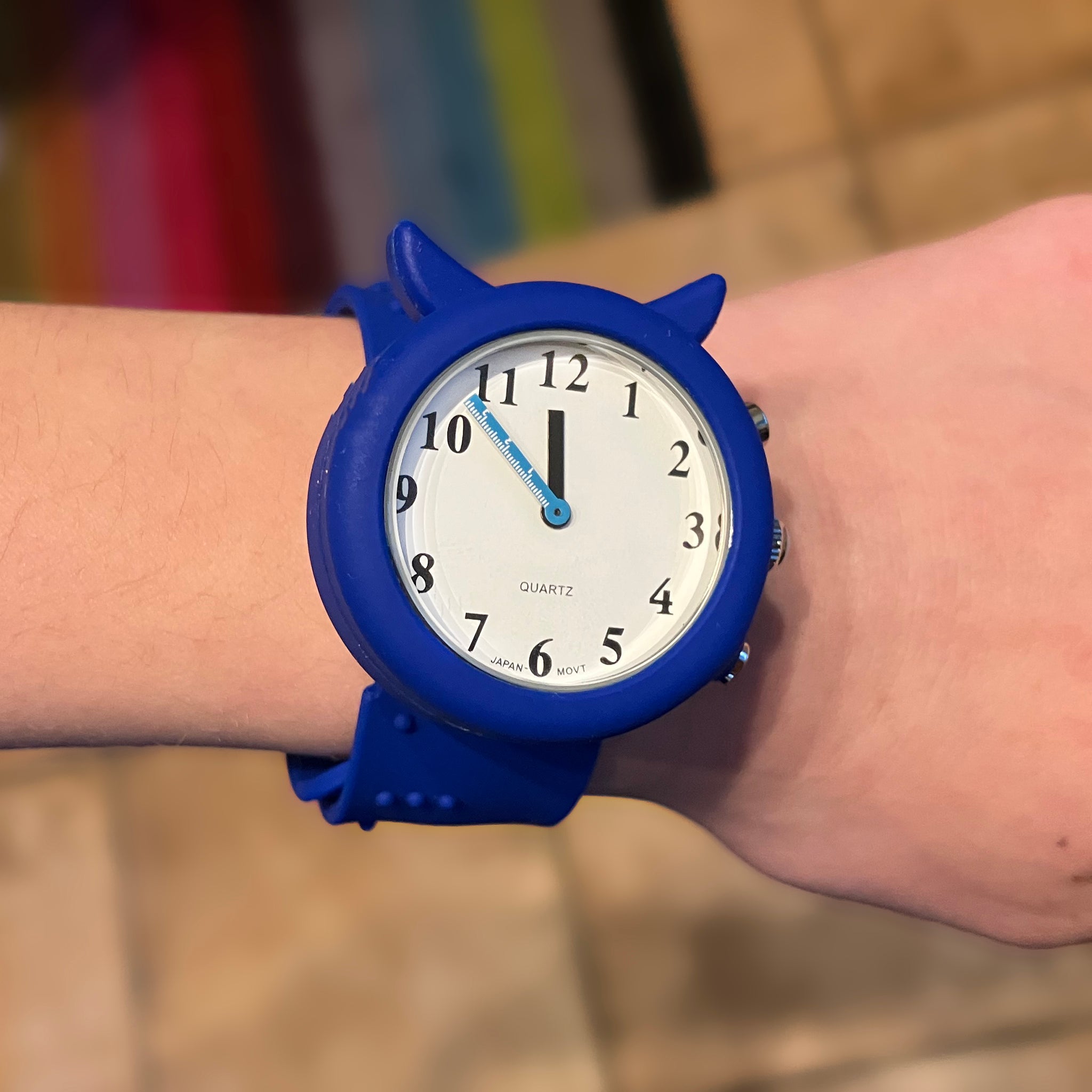 Blue slap on wrist strap talking children's watch being worn