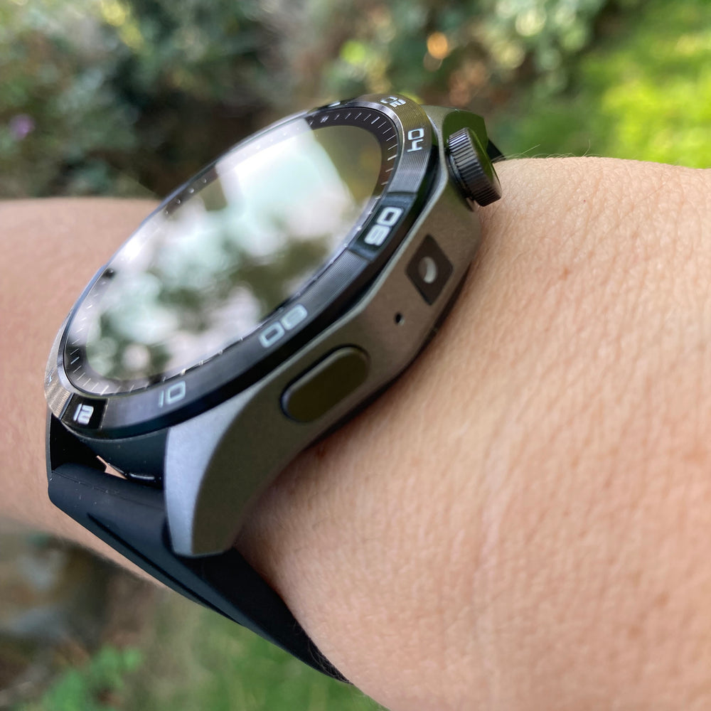 Watch on a wrist showing the crown and control button