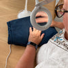 Someone using the magnifier and light while sewing