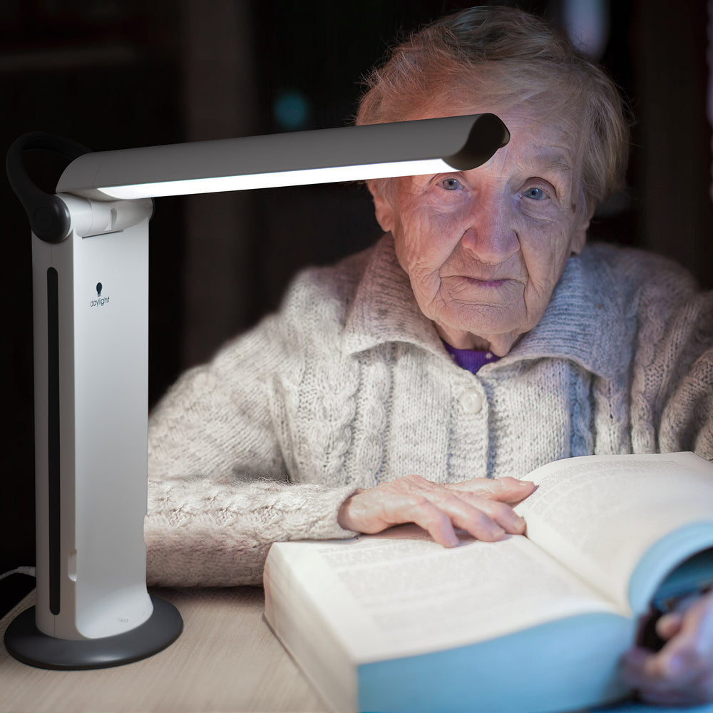 A woman using the Twist light to read