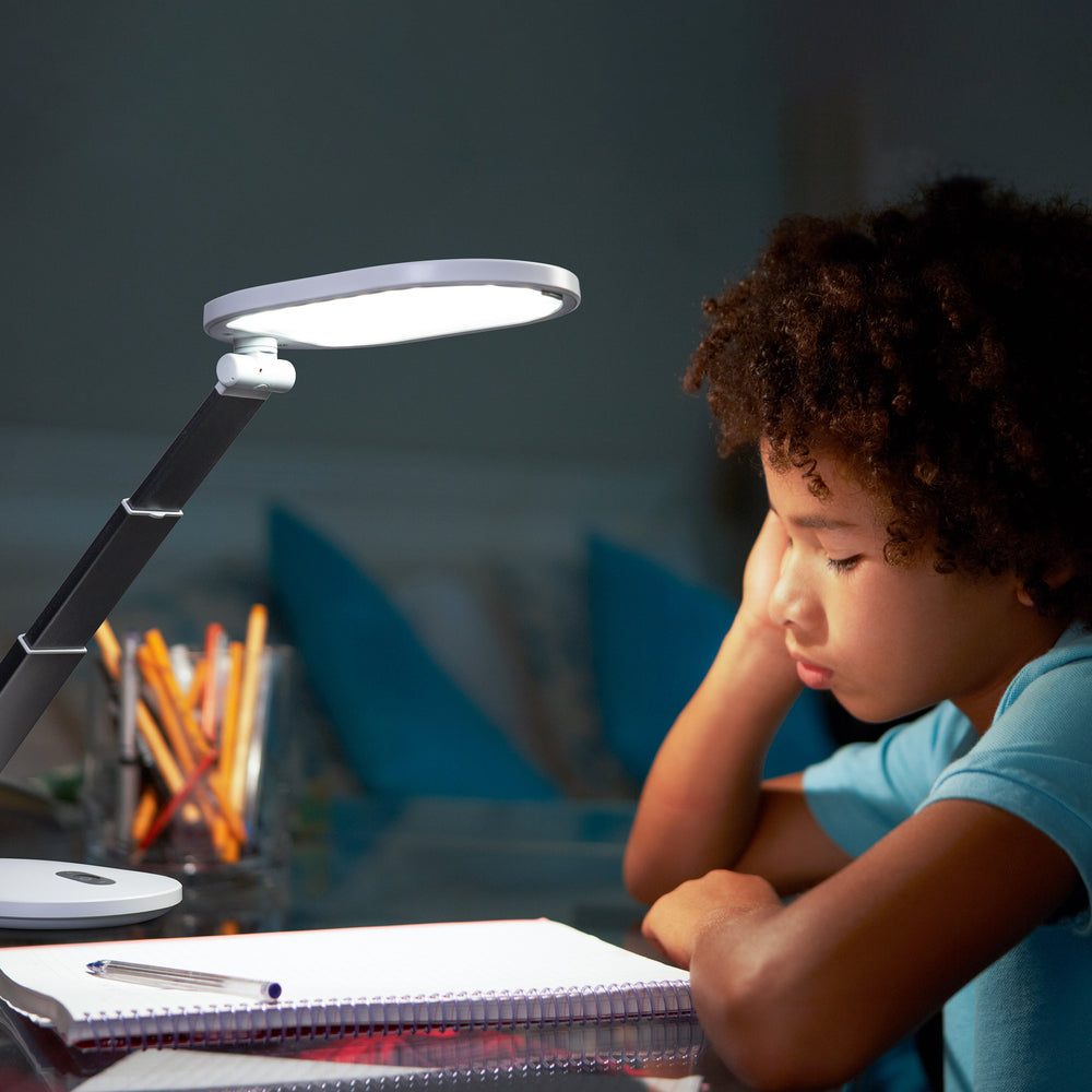 A boy using the light to study