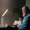 A man using the light to read a book