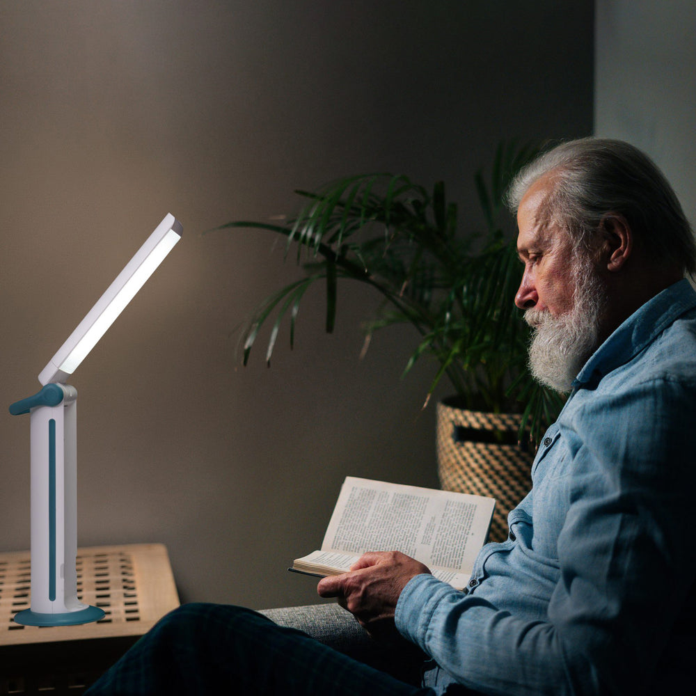 A man using the light to read a book