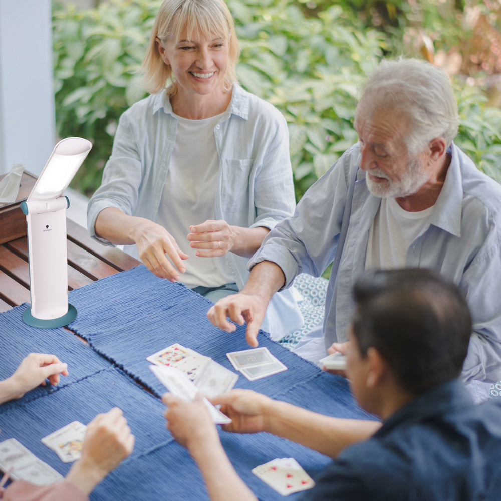 Four people using the light while playing cards