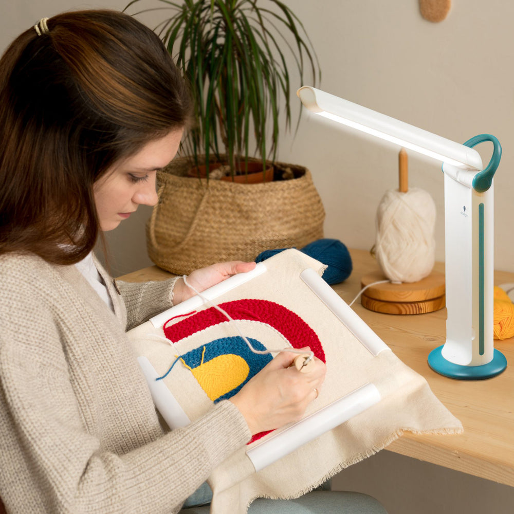 A woman using the light while sewing