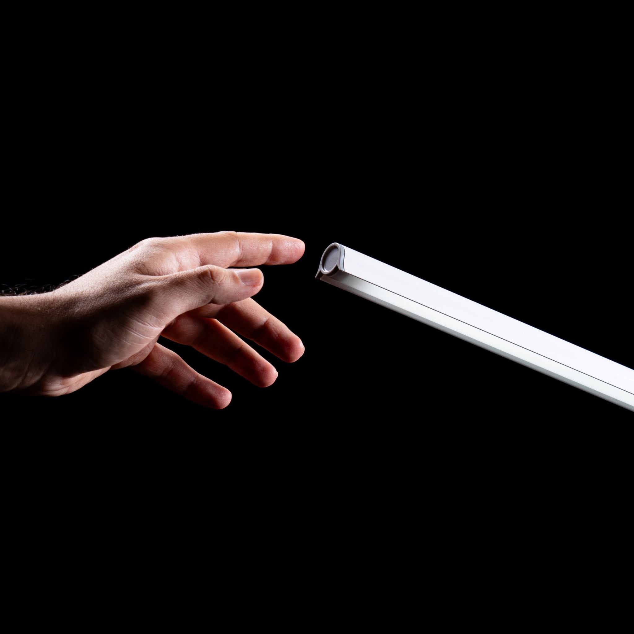 A hand reaching for the UnoPro's power button