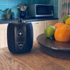 RNIB Accord on a wooden surface in a kitchen next to a fruit bowl.