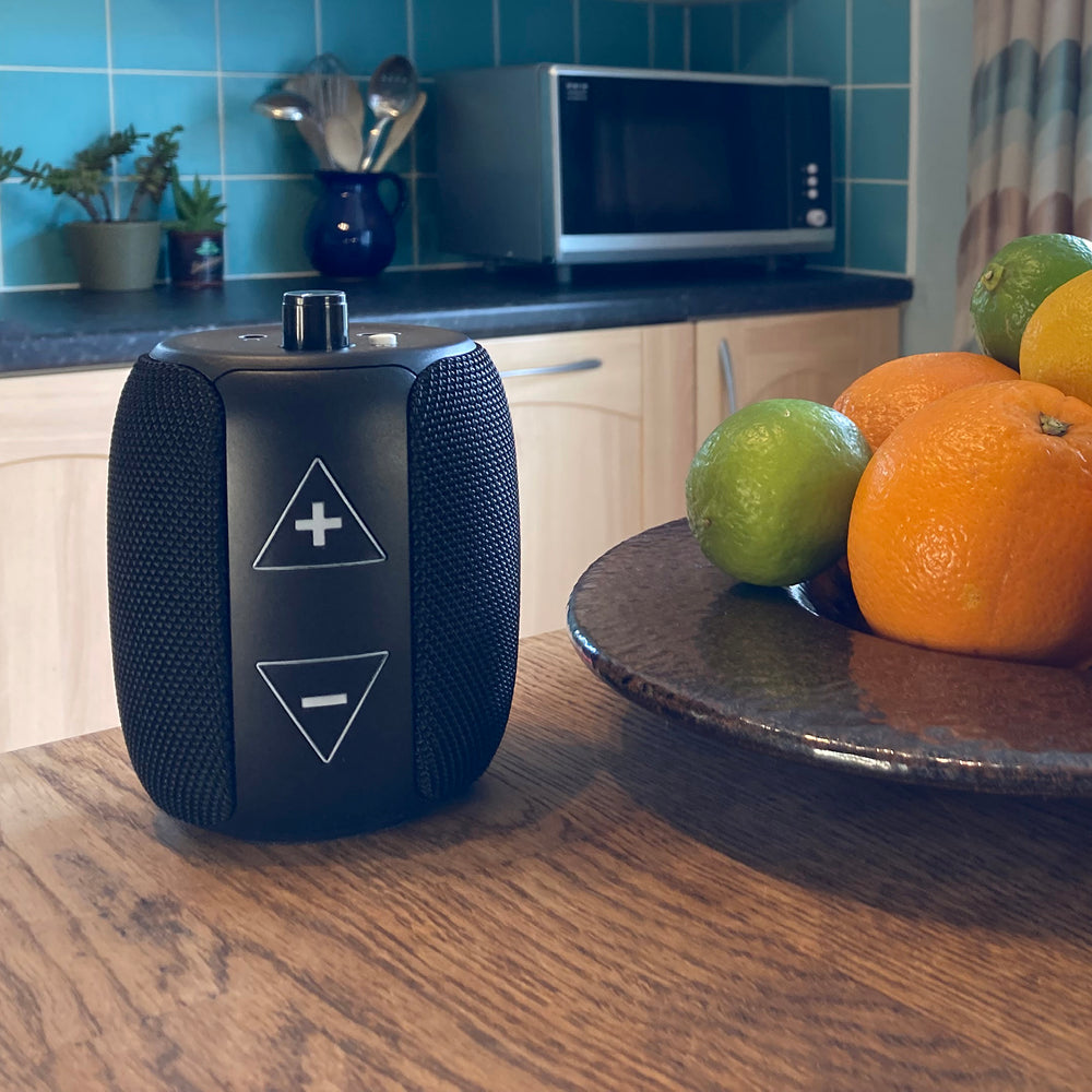 RNIB Accord on a wooden surface in a kitchen next to a fruit bowl.