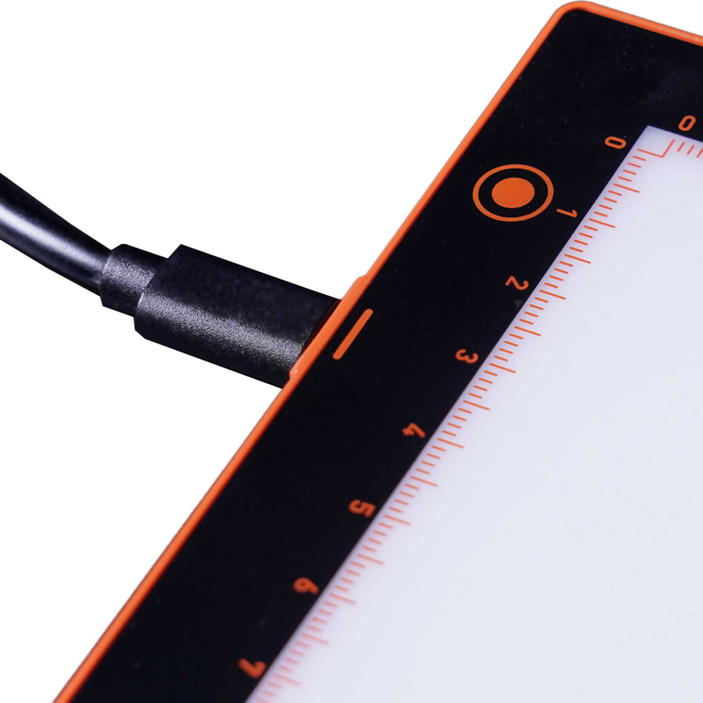 Close up view of the A4 lightboard showing a charging lead attached.