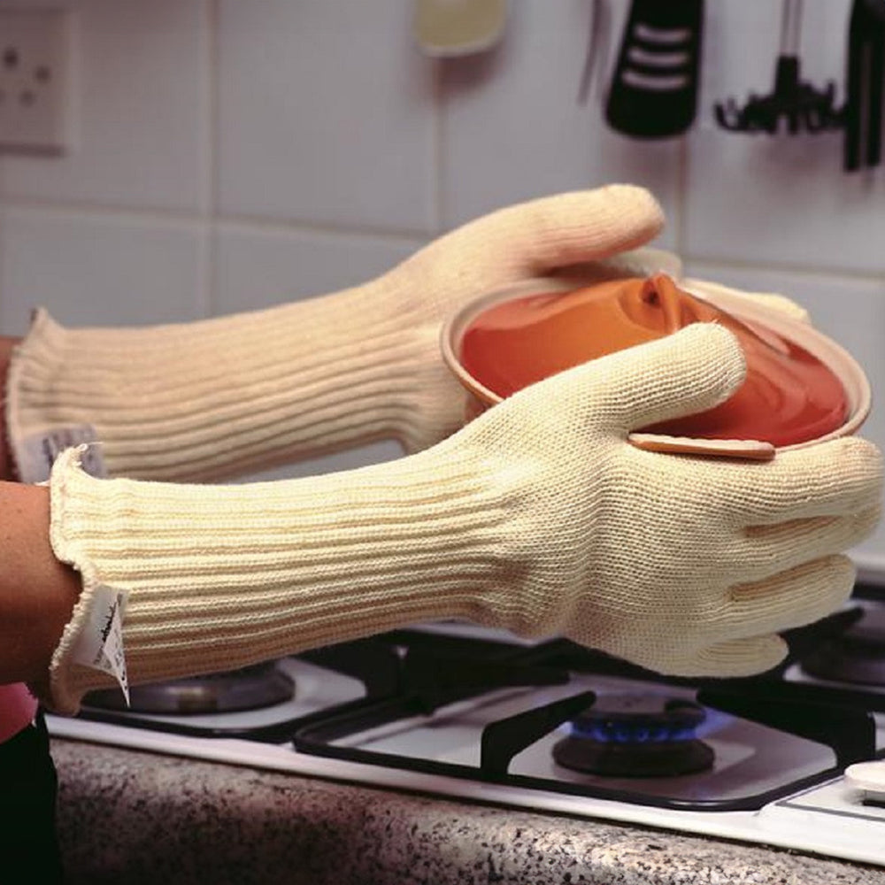 Someone wearing the oven gauntlets and holding a casserole