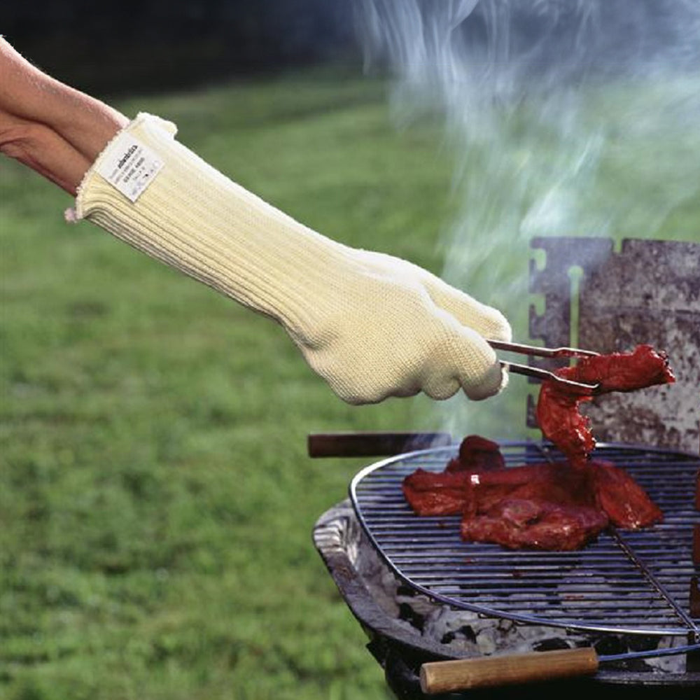 Someone wearing the oven gauntlets while barbecuing 