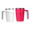 White and coral anti-spill mugs next to each other on a white background
