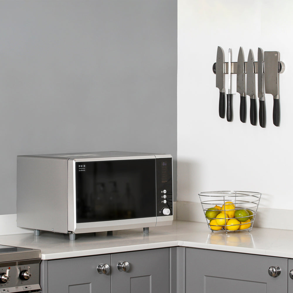 The RNIB talking microwave microwave on a counter top in a kitchen setting.