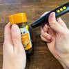 Someone using the PenFriend to identify a jar of spice