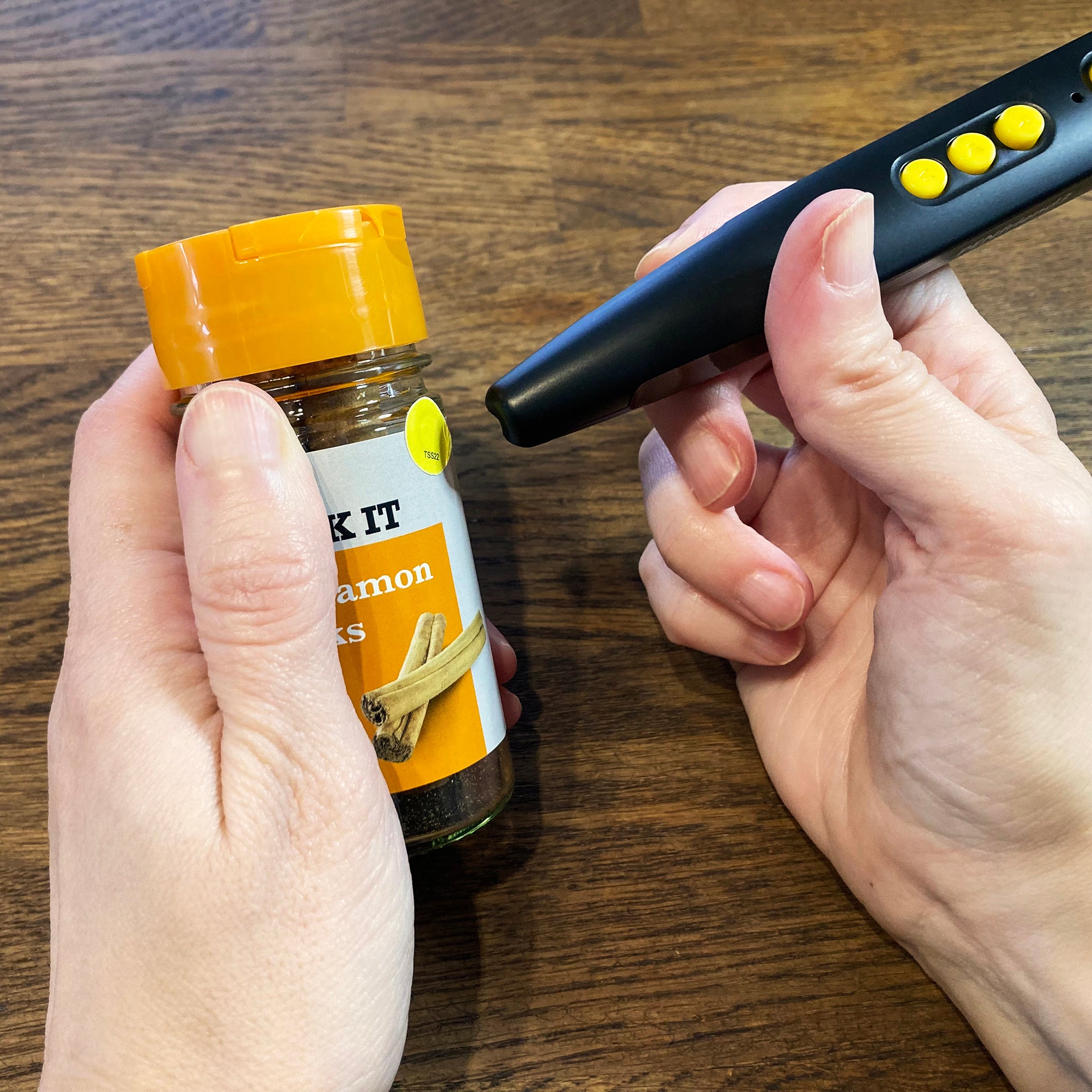 Someone using the PenFriend to identify a jar of spice