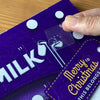 Someone applying a braille number sticker to an Advent calendar
