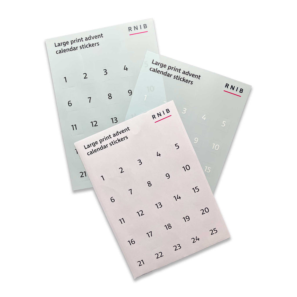 Three sheets of RNIB Large Print Advent Calendar Stickers arranged diagonally on a white background.