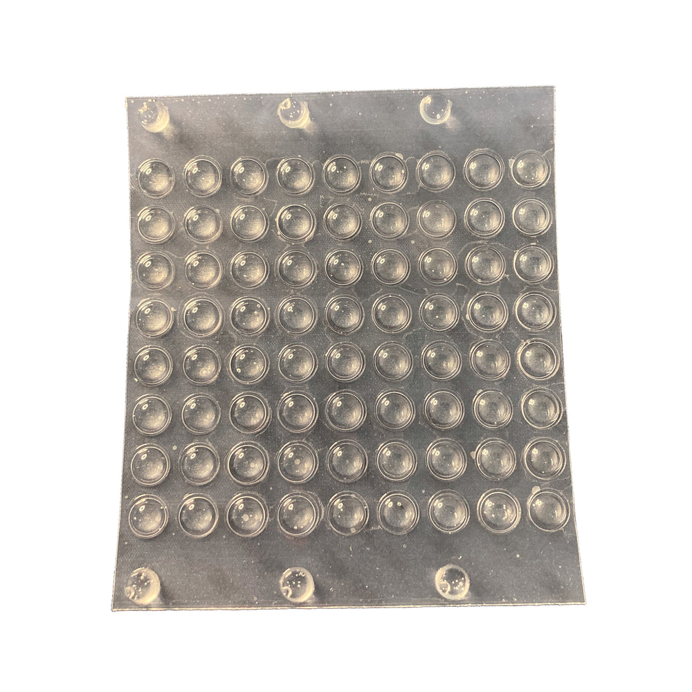 Sheet of small clear round tactile bumps
