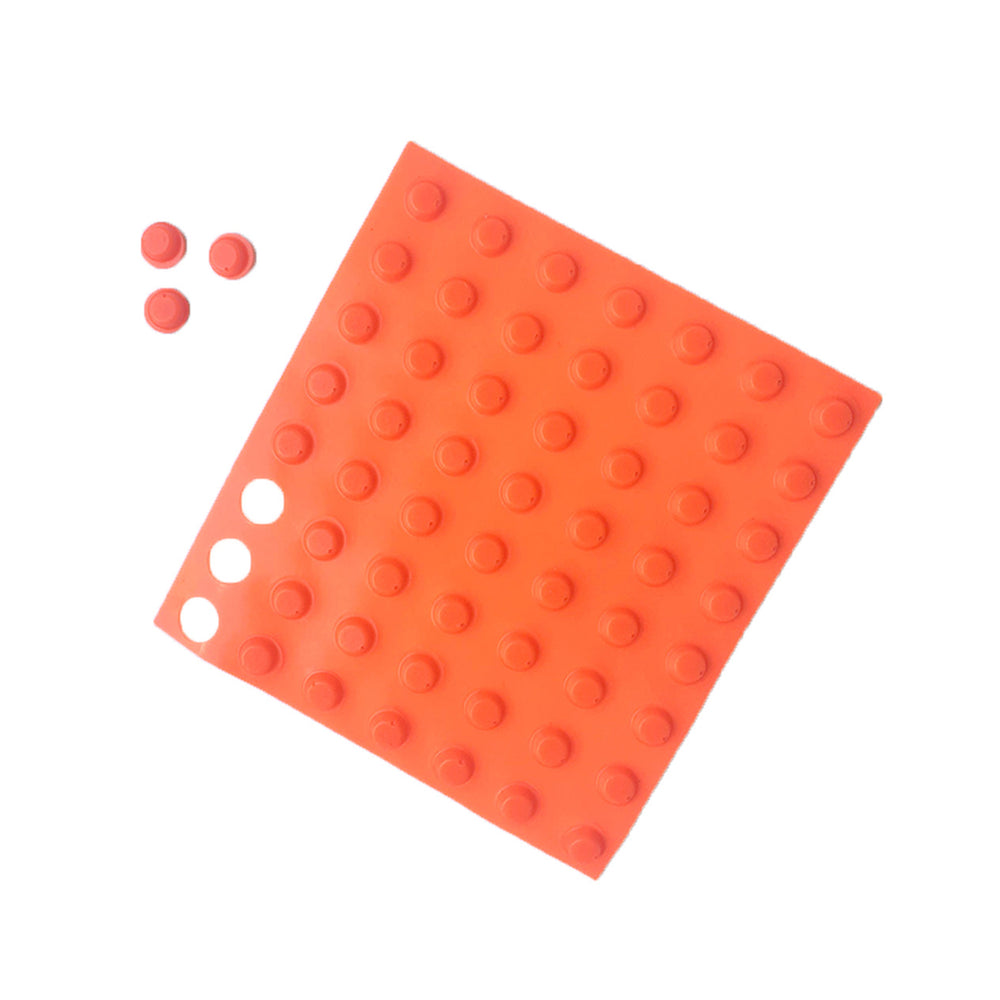 Sheet of orange Bumperstops with three dots placed nearby