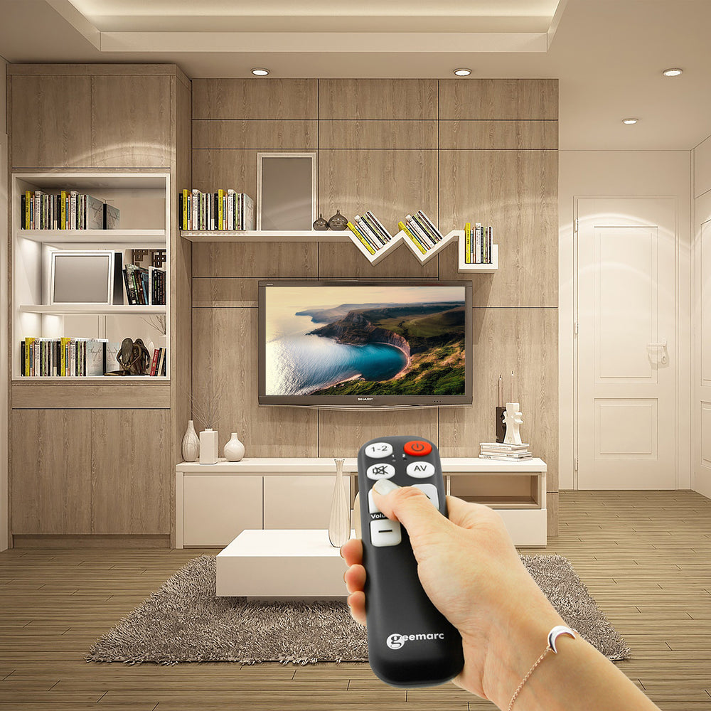 Someone using the remote control to change channel on their TV