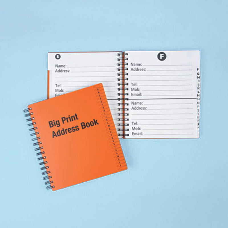 Two address books, one open showing page layout and the other closed showing the cover