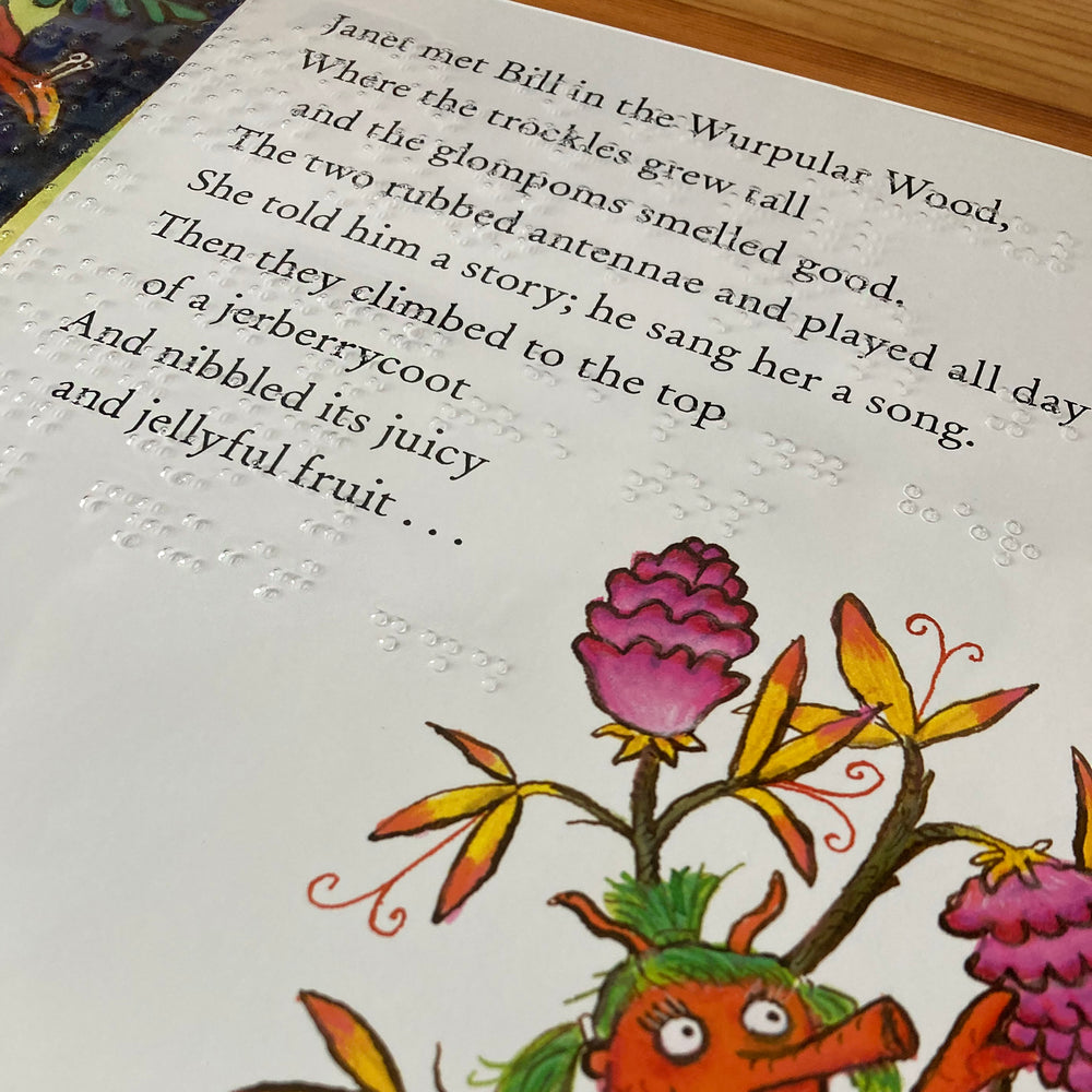 Illustrated book page with a creature and flowers, featuring written text and braille