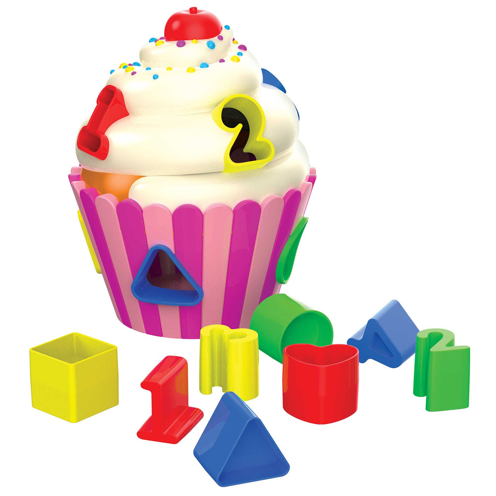 A colorful plastic cupcake-shaped toy with white frosting, multicolored sprinkles, and number cutouts, shown with several loose geometric and number pieces in front on a plain white background.