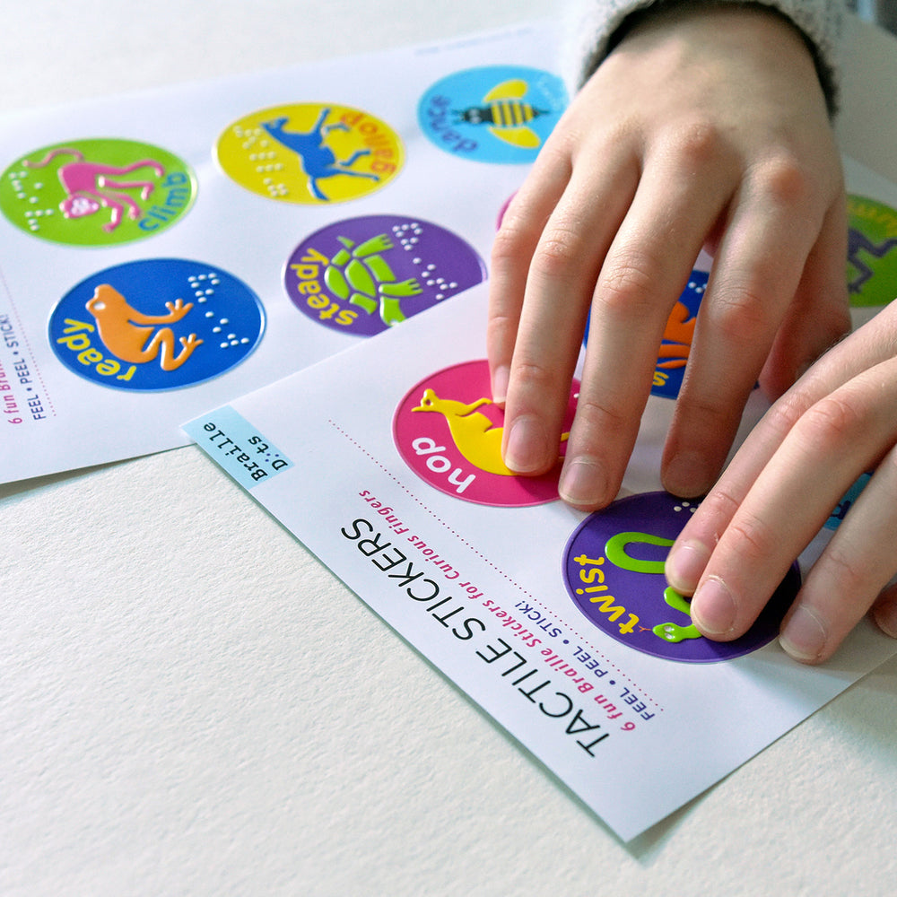 A person feeling the tactile image on a tactile sports reward sticker