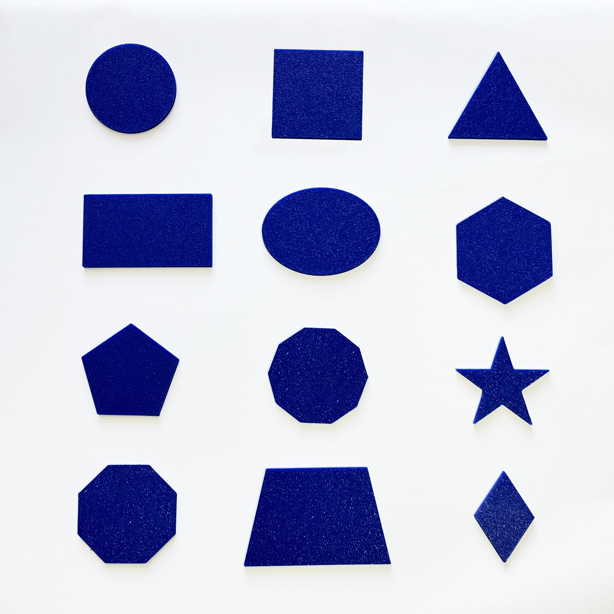 Blue 3D tactile shapes on a white background.