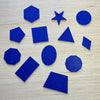 Blue  3D tactile shapes on a wooden table top.