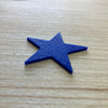 A blue star on a wooden table top.