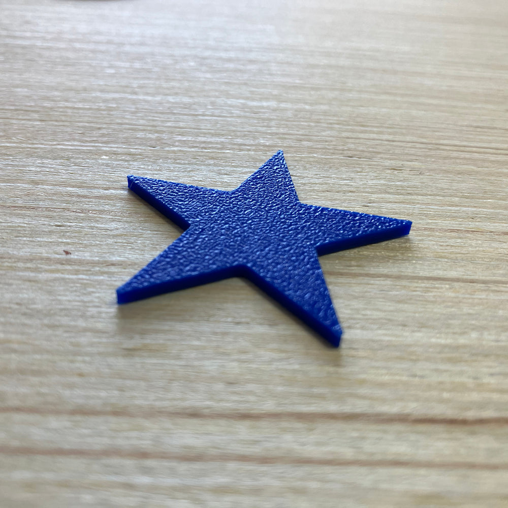 A blue star on a wooden table top.
