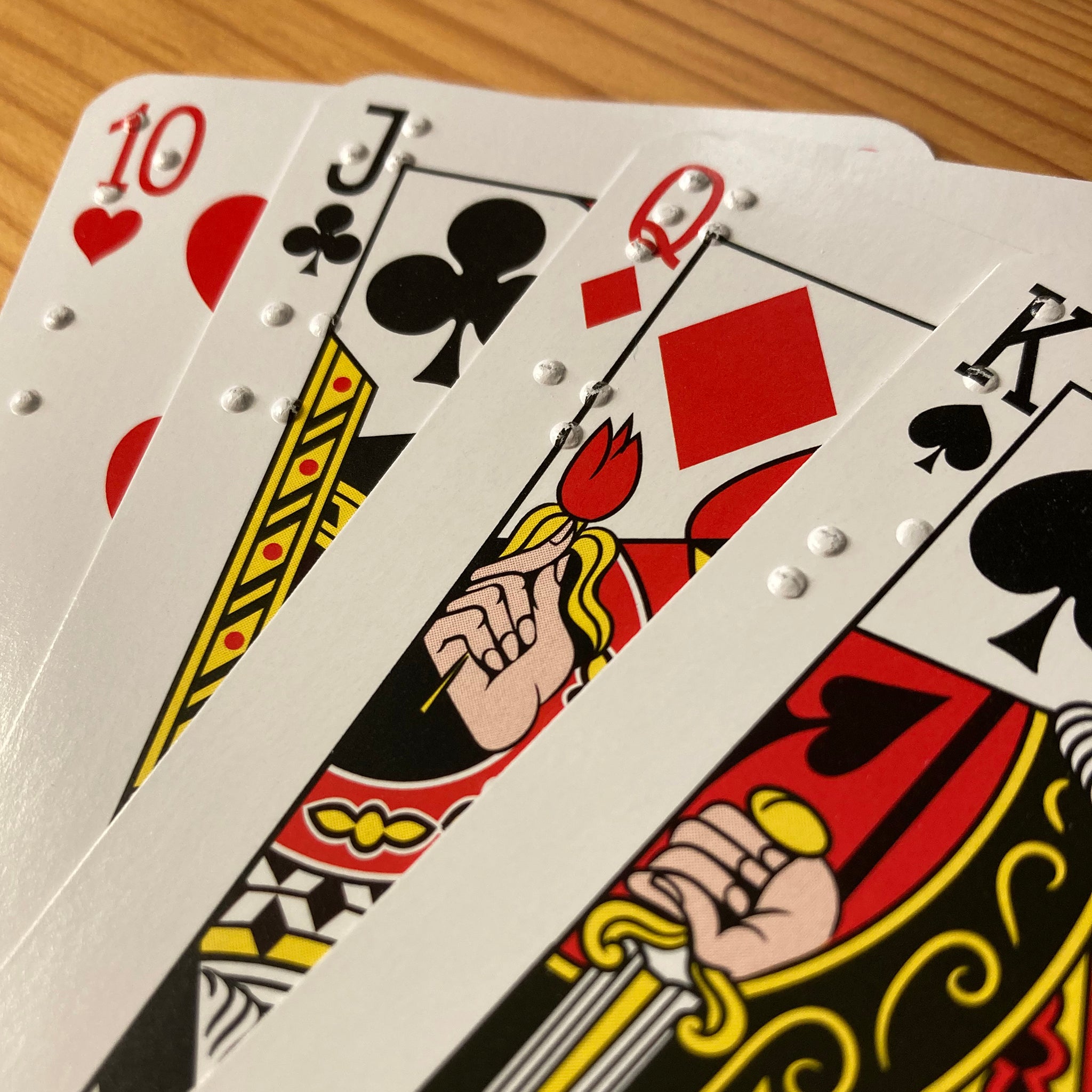 Close up of braille on fanned cards from 10 to King