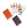 Four playing cards fanned out next to one pack showing red backs and another showing blue backs