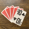 Large print playing cards fanned out showing the front of the 10 card and back of the red pack.