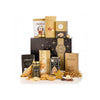 A luxury gourmet food gift hamper featuring an assortment of chocolates, biscuits, and treats arranged in front of a black and gold gift box on a white background. Visible brands include Lindt, Lindt Belgium, and Lindt's.